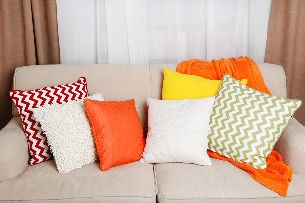 Colourful cushions on a sofa used to decorate your static caravan, adding comfort and a vibrant splash of personality to the space.
