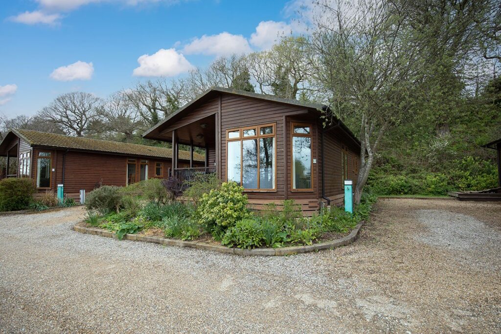 Stunning holiday homes at Waveney River Centre, set against a peaceful backdrop with modern exteriors and scenic views.