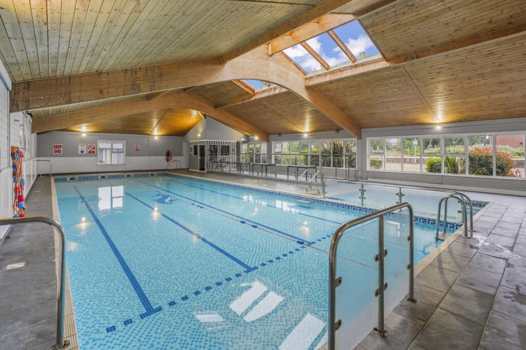 One of the swimming pools in Norfolk and Suffolk, showing the Broadlands Park & Marina Swimming Pool with modern indoor facilities and scenic views.