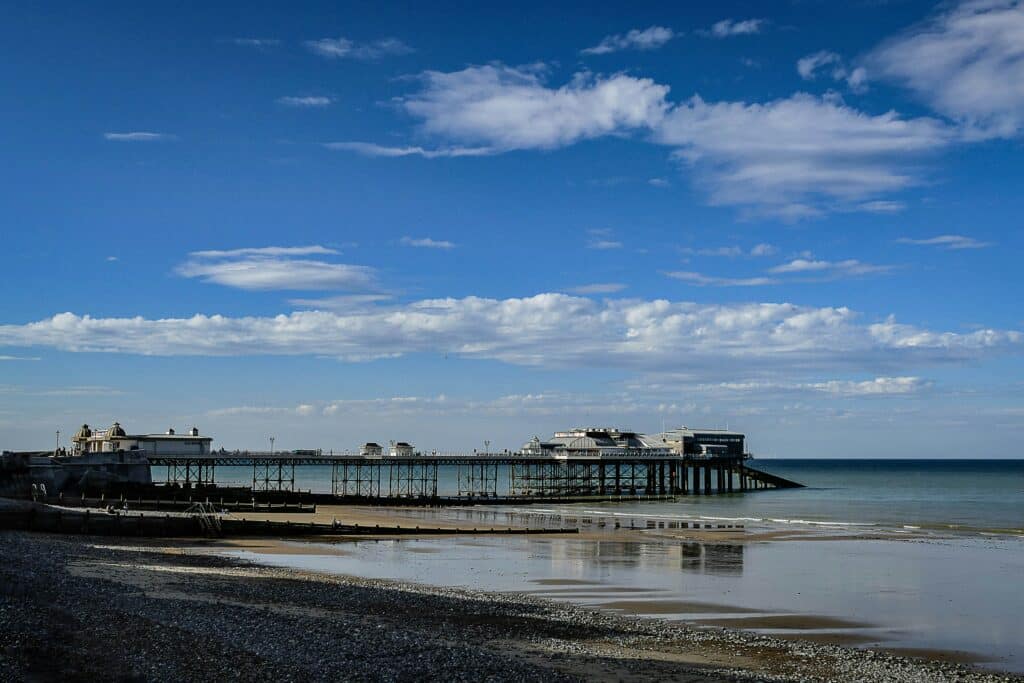 Cromer Pier on a clear day, a popular seaside attraction and one of the places to see a romantic sunset in Norfolk.