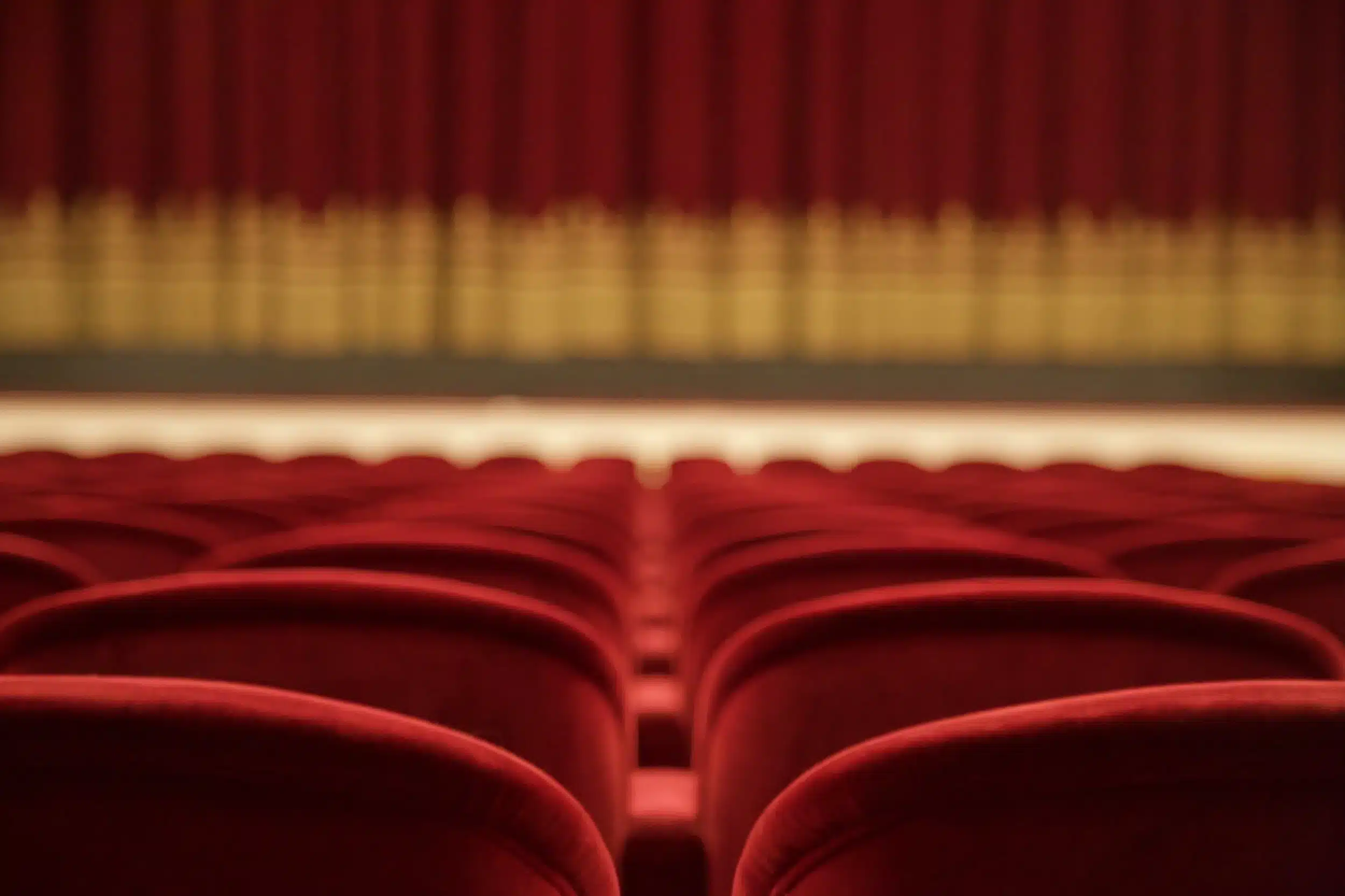 Vacant red seats inside a theatre auditorium