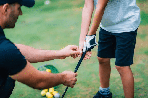 Man teaching child to play golf, close up shot