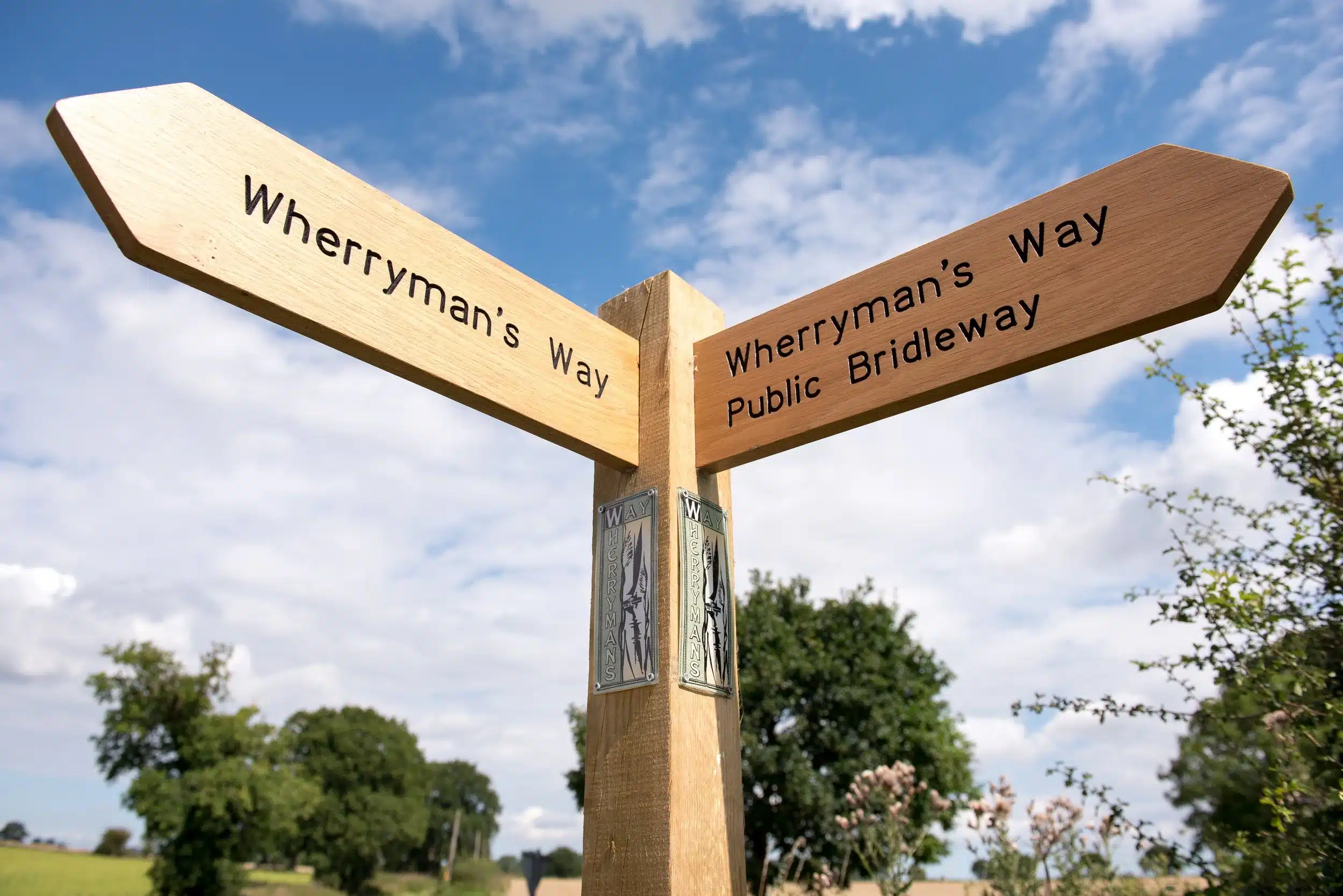Directional wooden signpost for Wherryman's Way and a public bridleway.