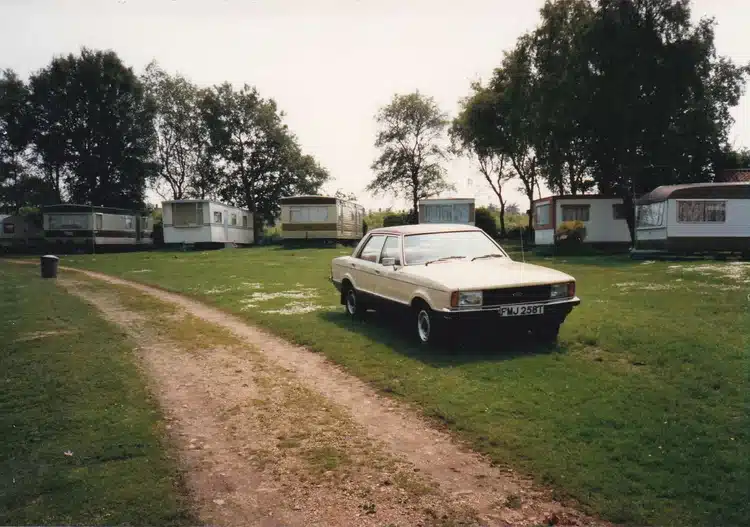 Car in front of static caravans