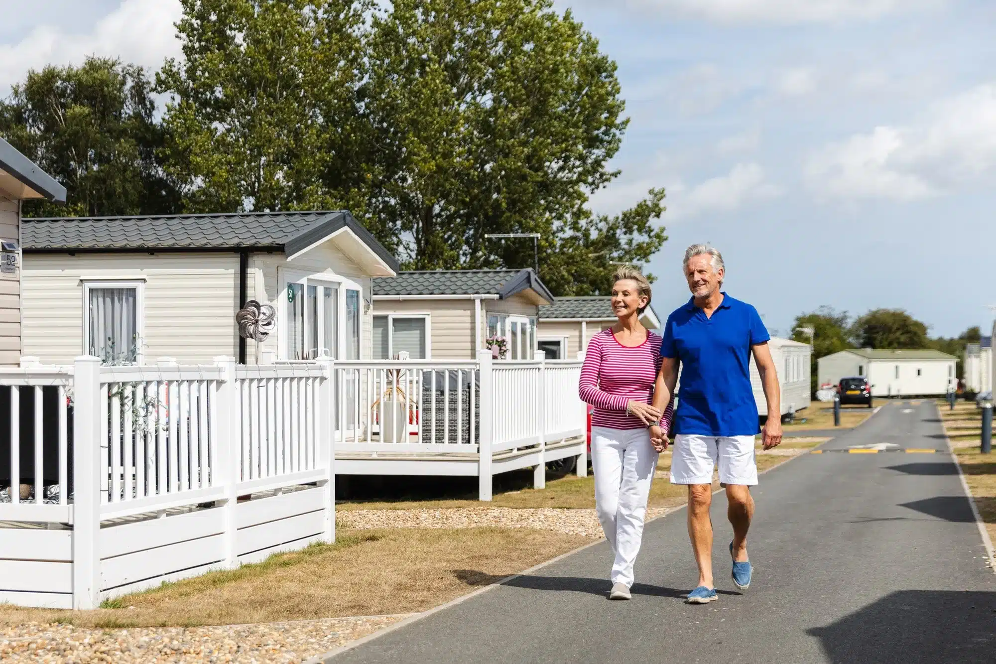 Couple walking happily through a holiday park