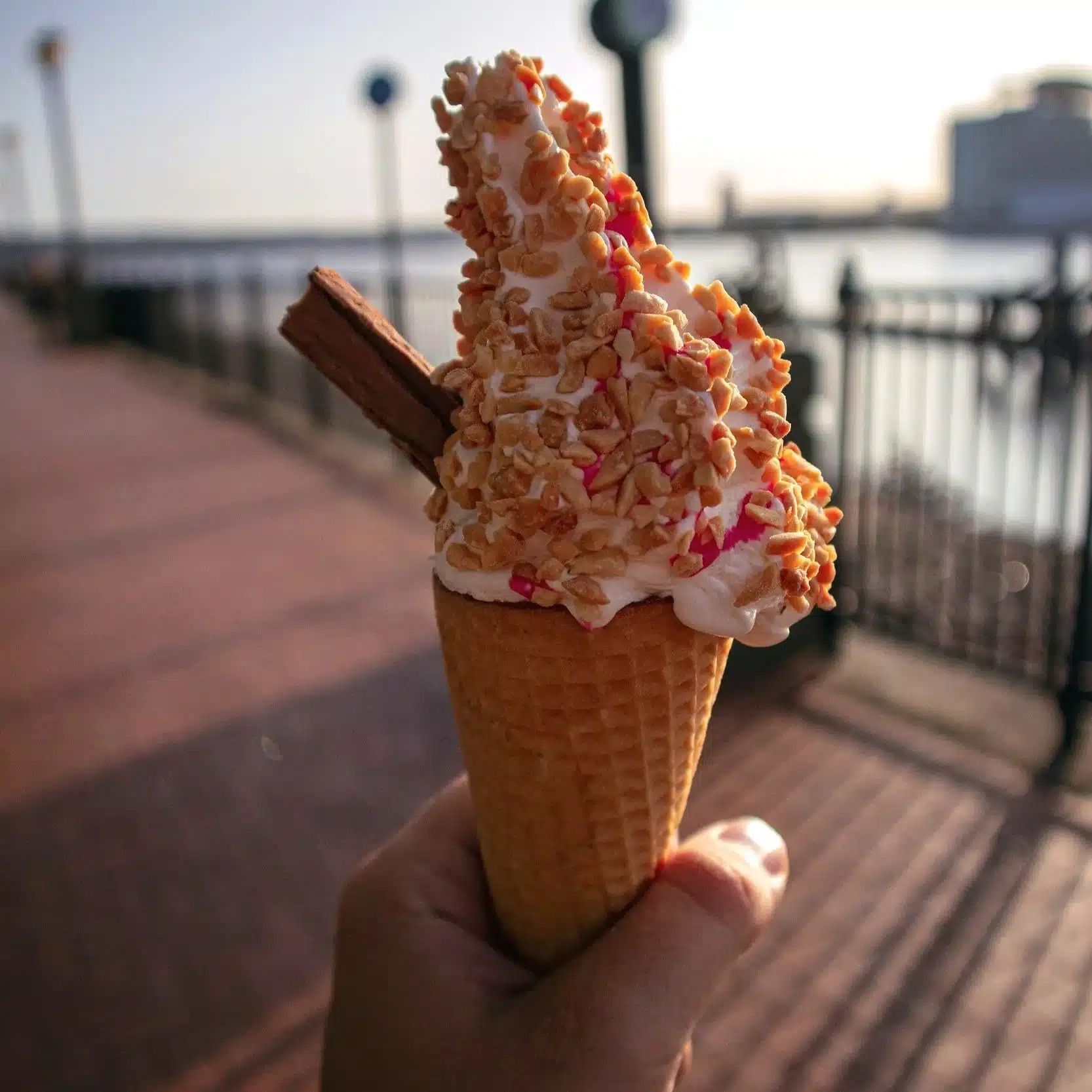 POV of holding a classic 99p Flake cone on a sunny day, capturing the joy of discovering where to get the best ice cream